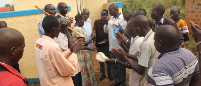 Assistant RDC Janol Okot handing over the Latrine keys to Chairperson Atek Central.