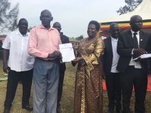 Hon. Amongi hands over PDM Voucher to one of the beneficiaries.